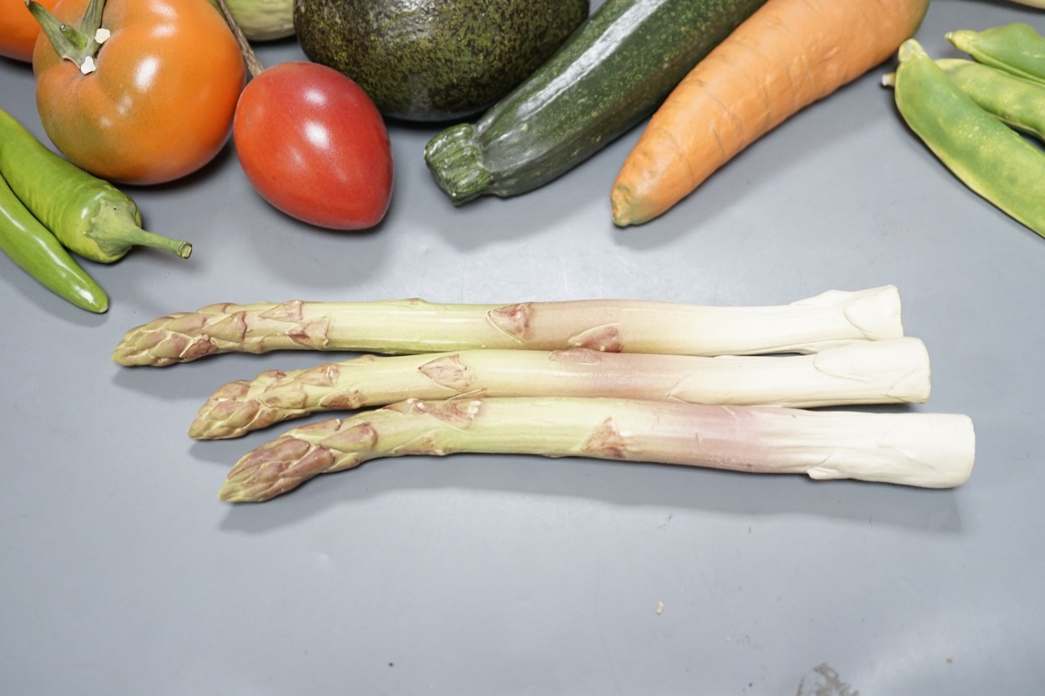 A collection of vintage Penkridge ceramic vegetables including an artichoke, avocado, peppers and asparagus (19 items)